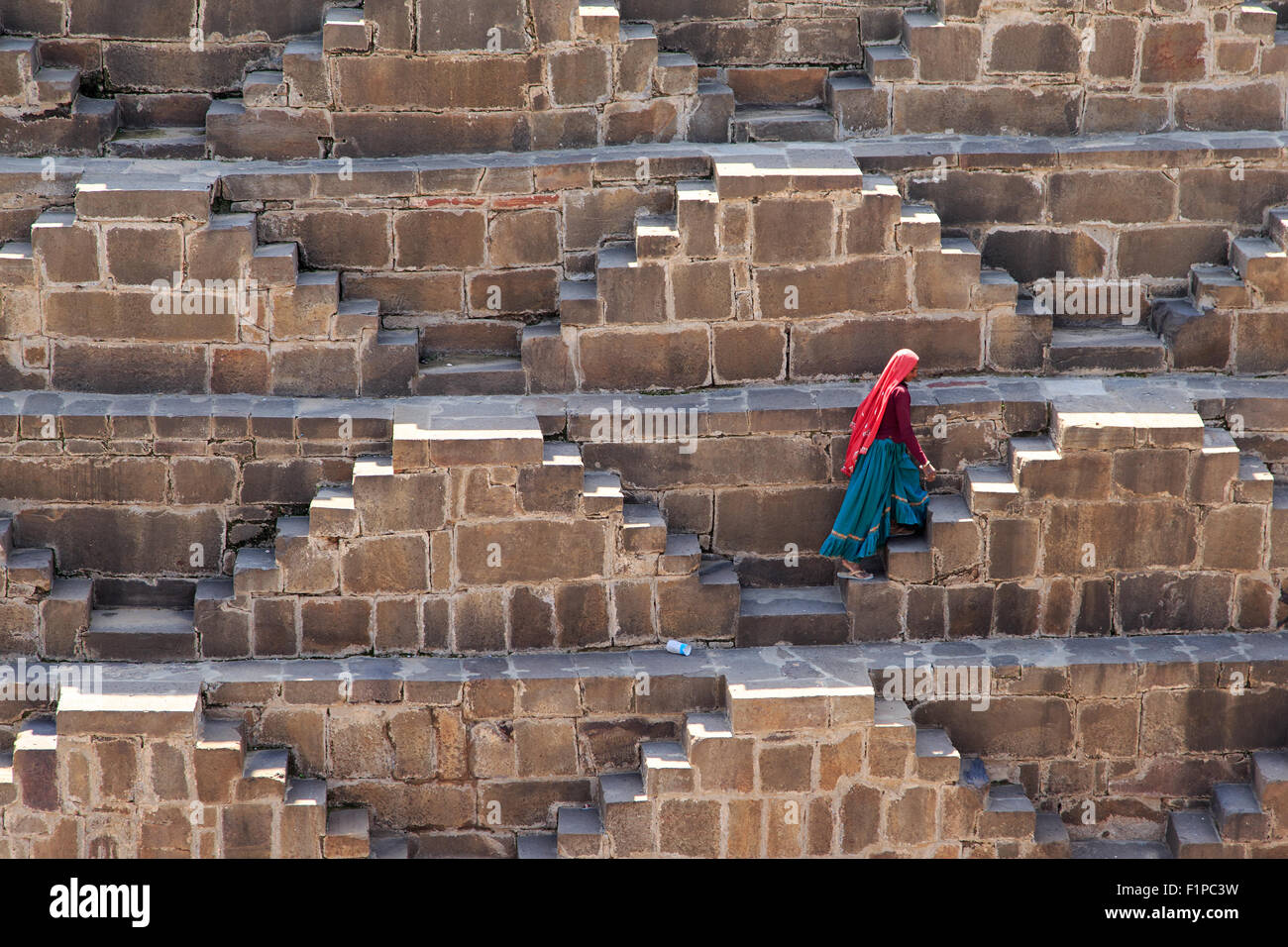 Une personne escalade les étapes de Chand Baori. L'un des village d'Abhaneri situé près de Bandikui, Rajasthan. Banque D'Images