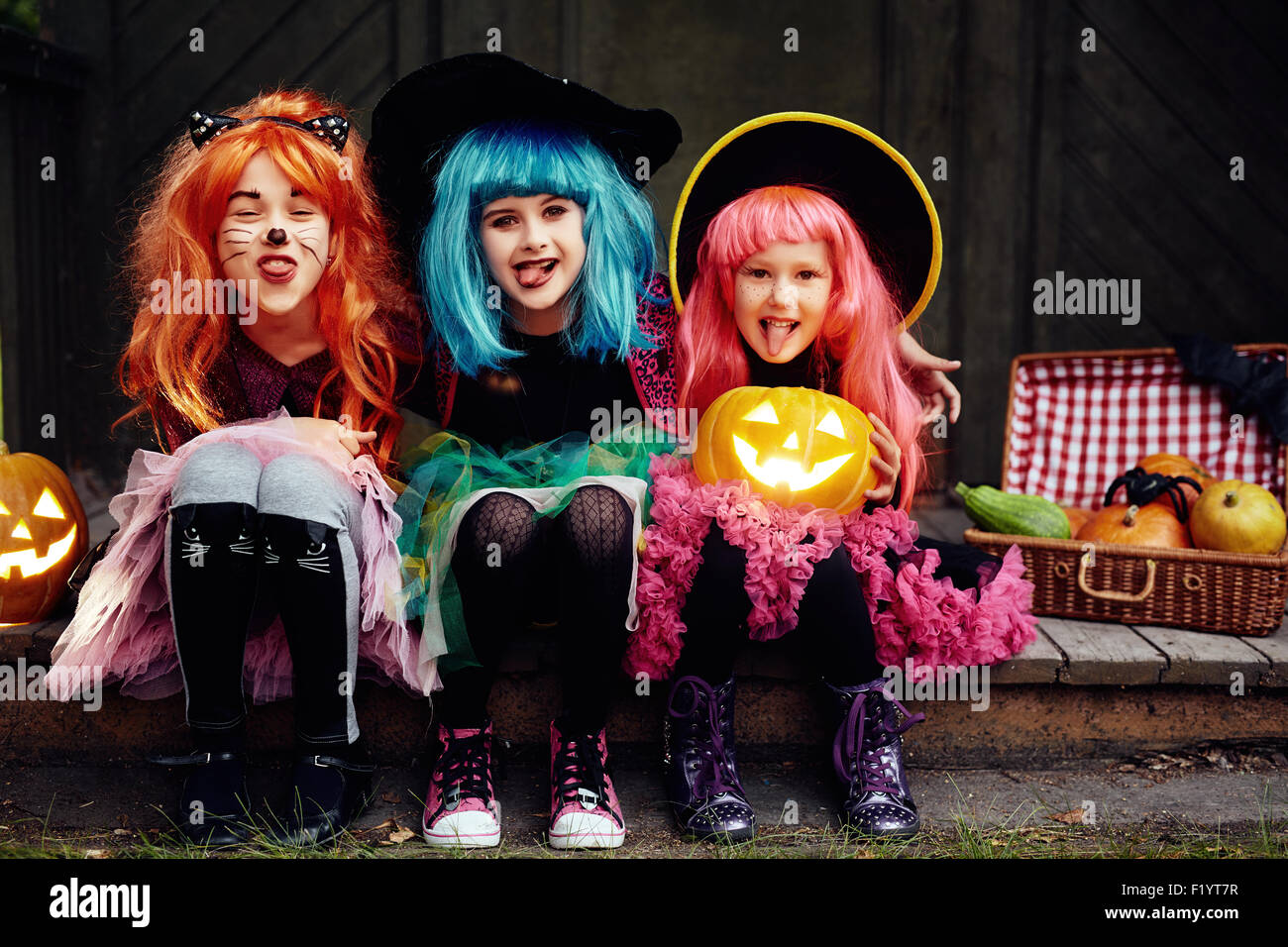 Funny Girls montrant langues et looking at camera le soir de l'Halloween Banque D'Images