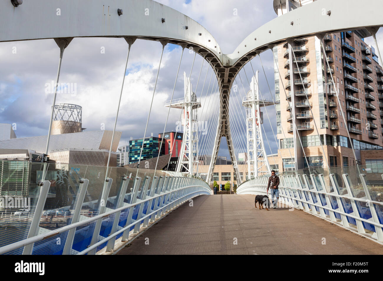 Une personne qui entre dans le pont levant de Salford Quays aussi connu sous le pont ou la passerelle du Millénaire Lowry, Salford Quays, Manchester, Angleterre, RU Banque D'Images