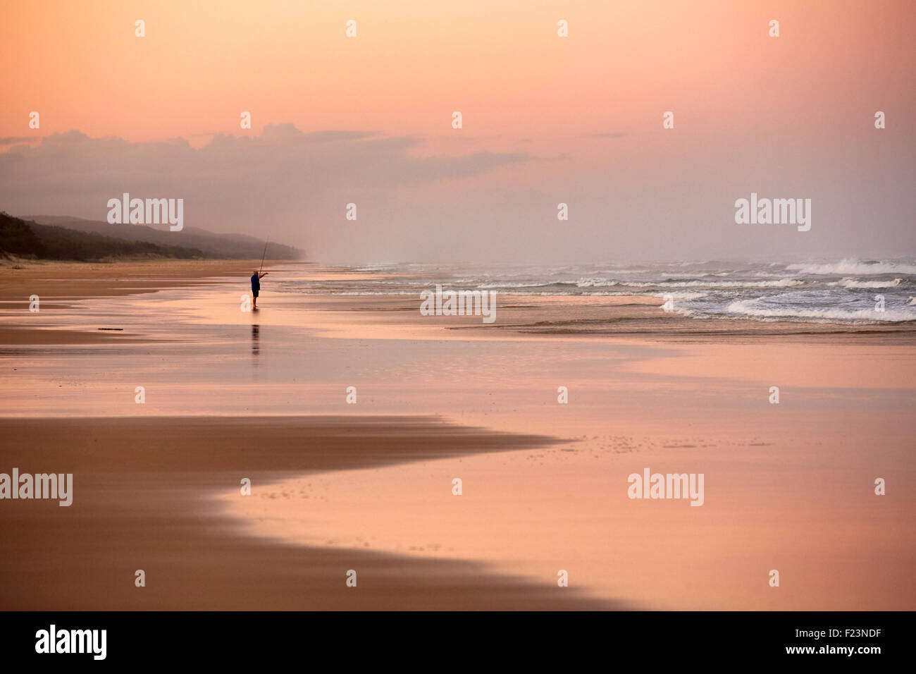 Pêcheur solitaire, sur Seventy Five Mile Beach, Fraser Island, renommé K'gari, Queensland, Australie. Banque D'Images