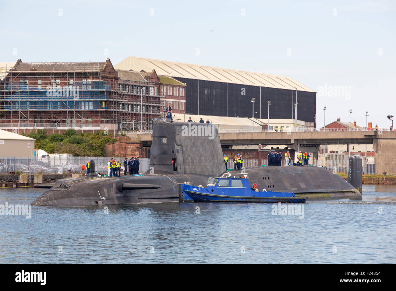 L'art de la classe Astute hunter killer un sous-marin nucléaire est déplacé de BAE Systems dans la région de Barrow in Furness jusqu'à la base de sous-marins de Faslane, en Écosse, au Royaume-Uni. Dans l'arrière-plan est le transport nucléaire de bateau, le Heron. Les sous-marins sont armés de torpilles Spearfish et missiles de croisière Tomahawk. Banque D'Images