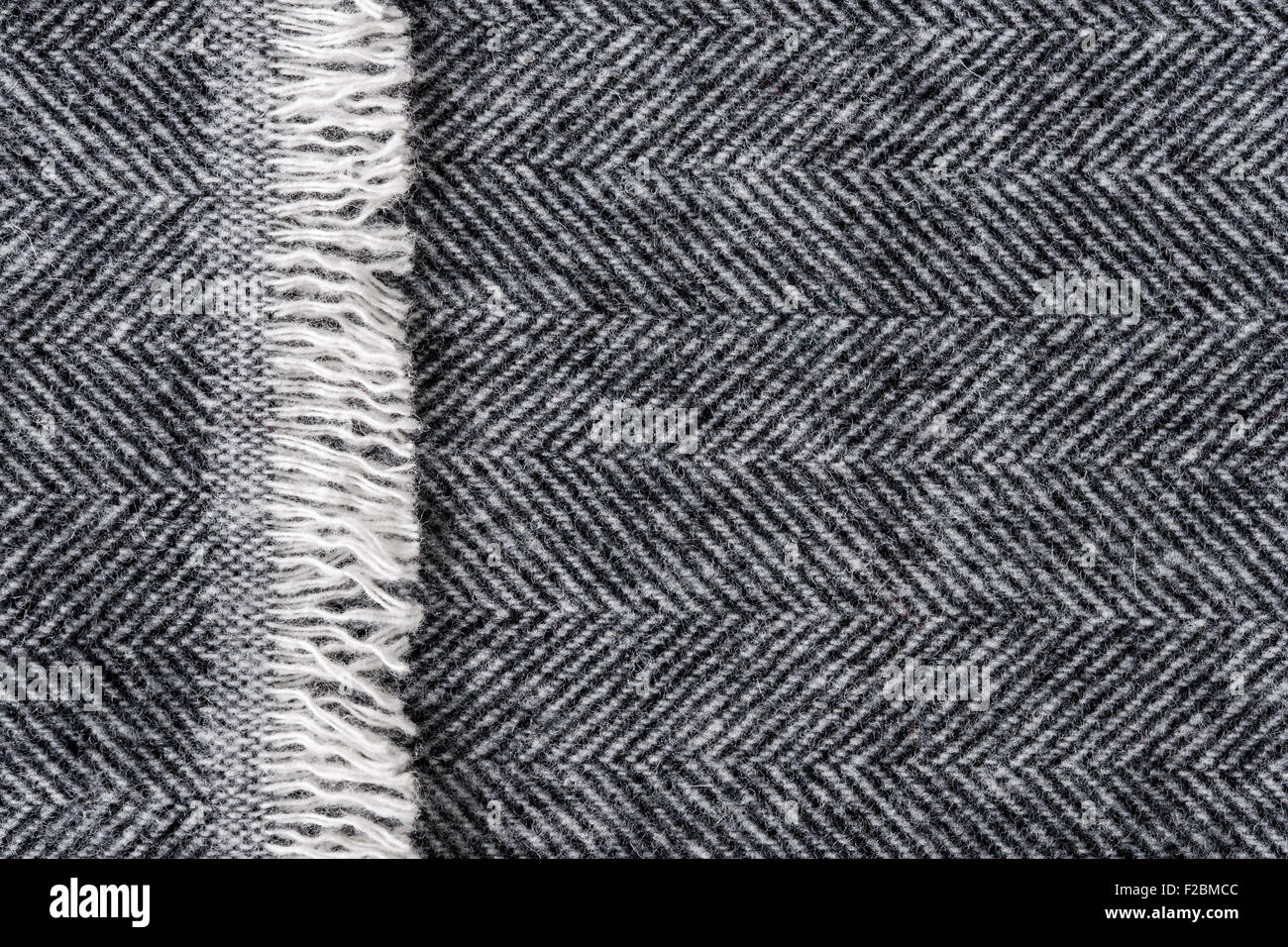 Fond tissu tweed de laine à chevrons avec gros plan sur la texture du textile et du chevauchement fringe edge Banque D'Images