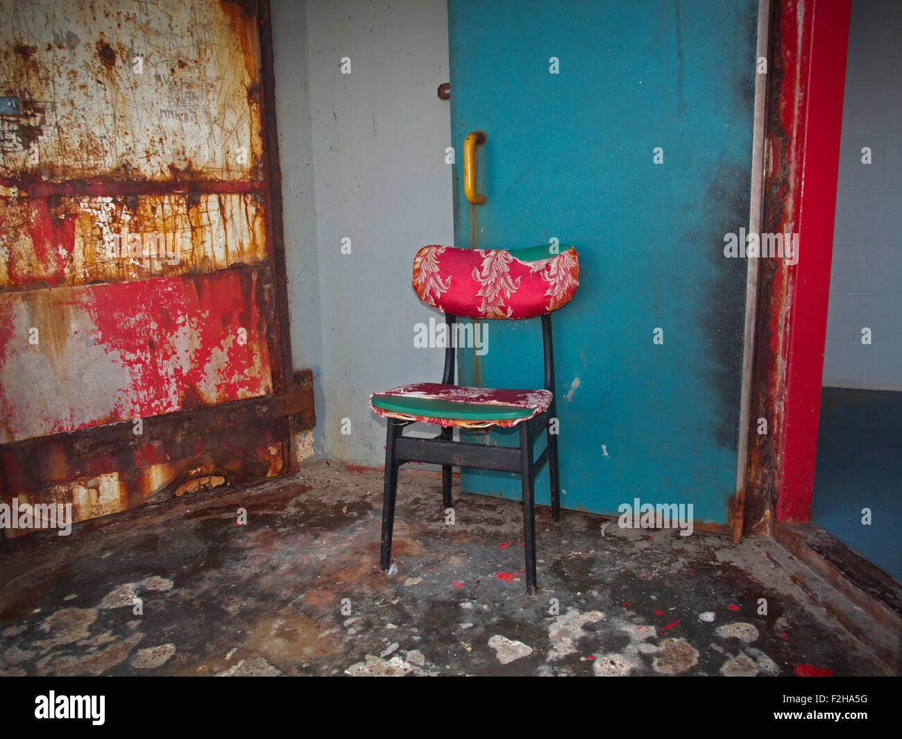 Un fauteuil rouge bleu accessoires ouvrir une porte de toilettes publiques à Brighton Banque D'Images