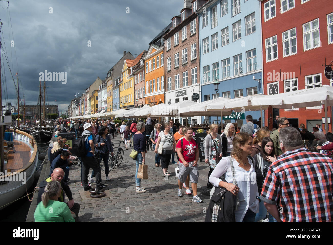 Les touristes de passage les maisons colorées contenant des bars et restaurants de la canal au nouveau port de Nyhavn Copenhague Danemark Banque D'Images