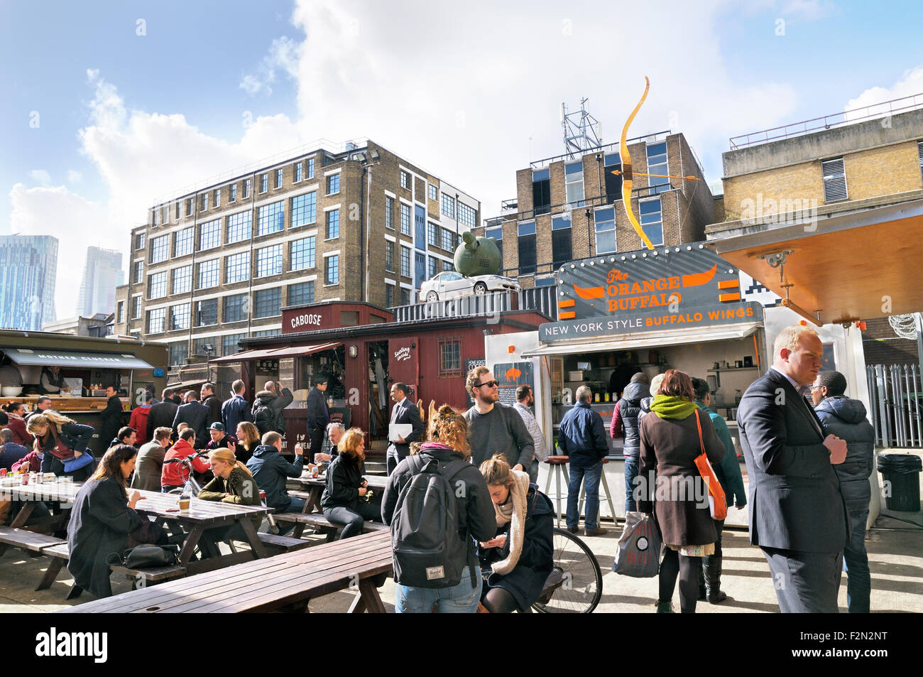 Les personnes achetant la restauration rapide et de boissons dans des Dray à pied, au large de Brick Lane, East London, England, UK Banque D'Images