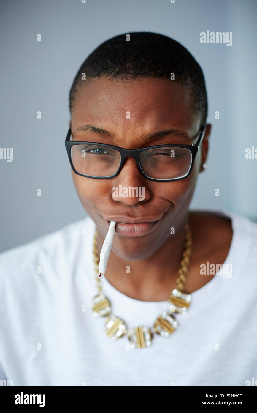 Close up of mixed race woman smoking cigarette Banque D'Images