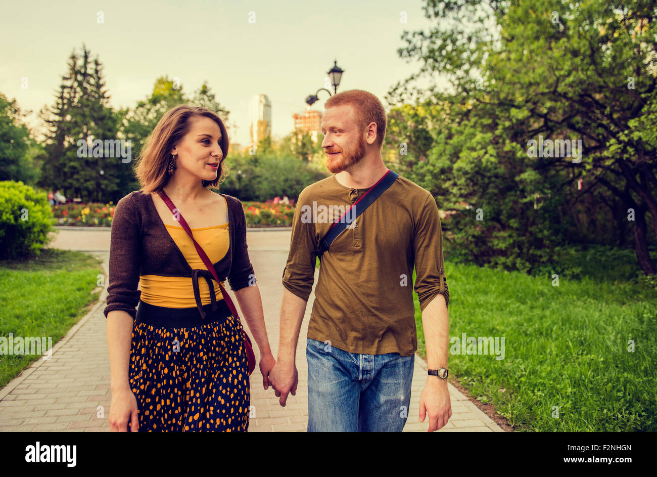 Caucasian couple holding hands in park Banque D'Images