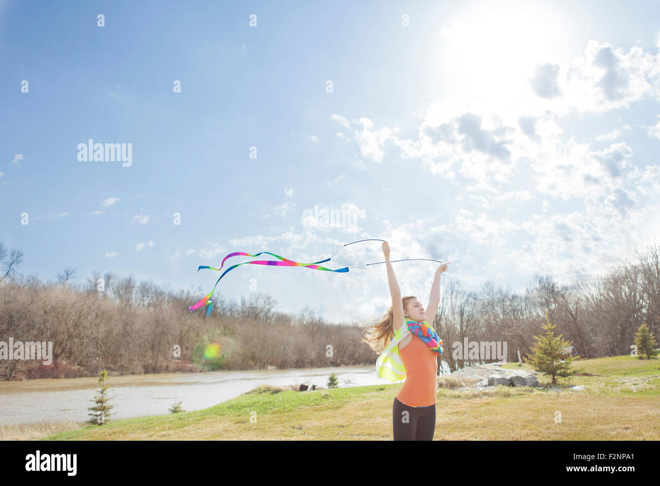 Caucasian girl Playing with ribbons in park Banque D'Images