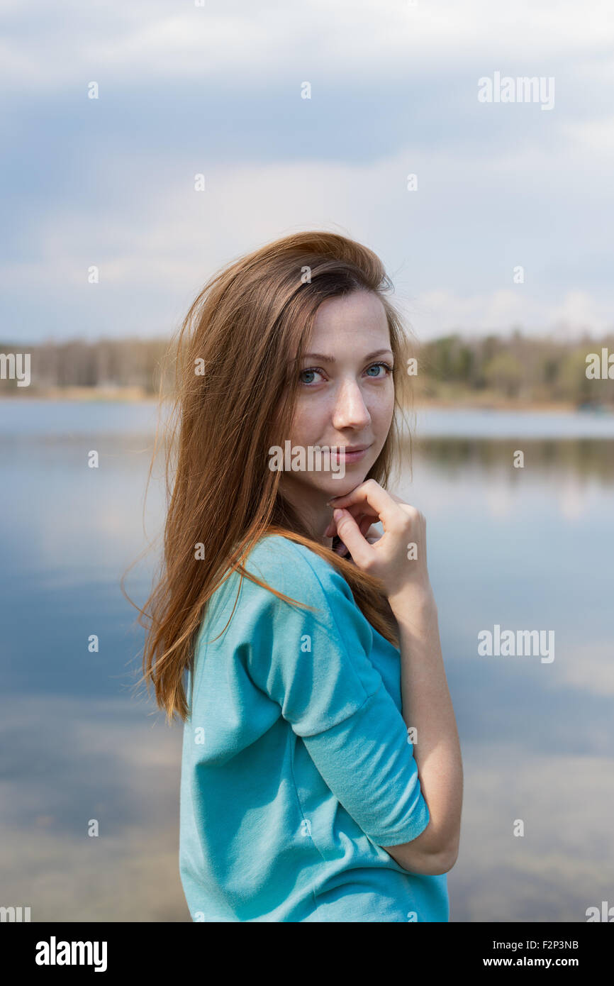 Des taches de rousseur happy girl looking at camera et de rêve sur le lac Banque D'Images