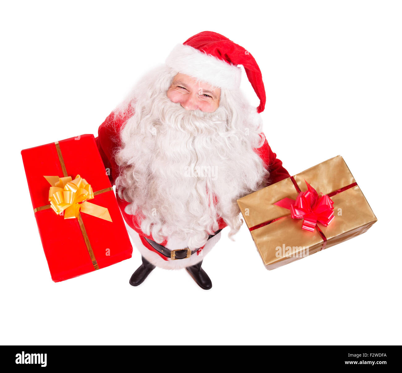 Santa Claus holding des cadeaux de Noël et à la caméra jusqu'à Banque D'Images