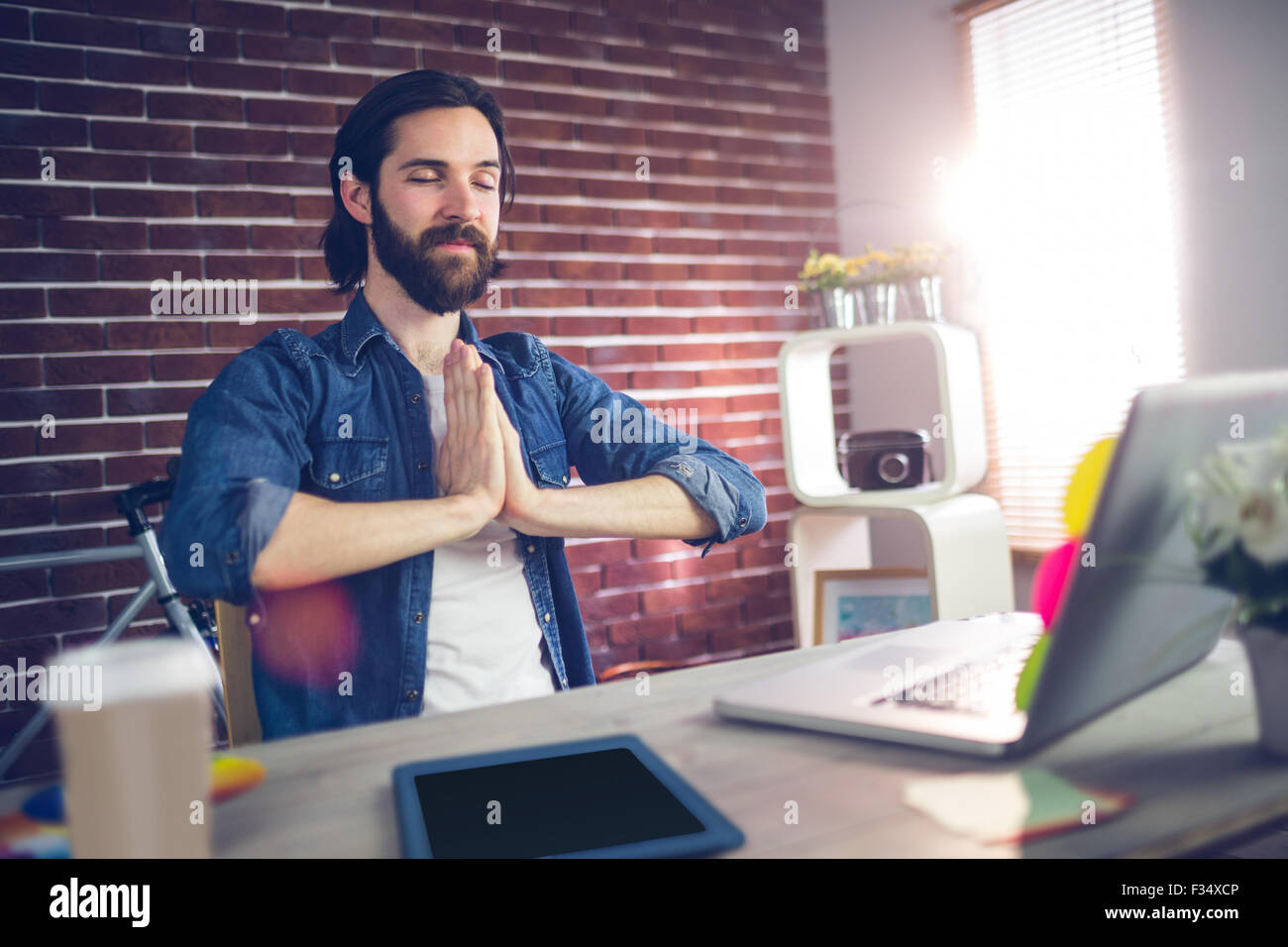 Businessman with hand clasped doing yoga Banque D'Images