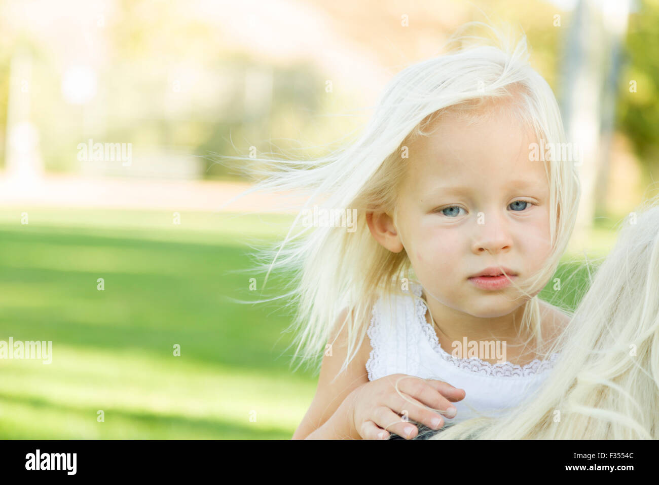 Mélancolie Portrait of cute little girl à l'extérieur dans le parc. Banque D'Images