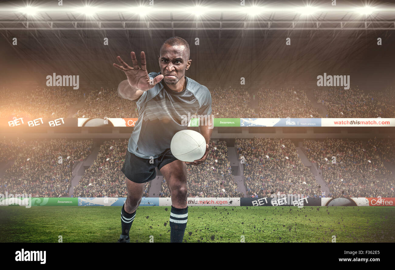Image composite de l'agressivité de rugby, gesticulant en maintenant ball Banque D'Images
