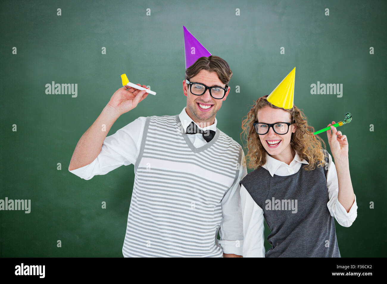Image composite de couple avec geek party hat and party horn Banque D'Images