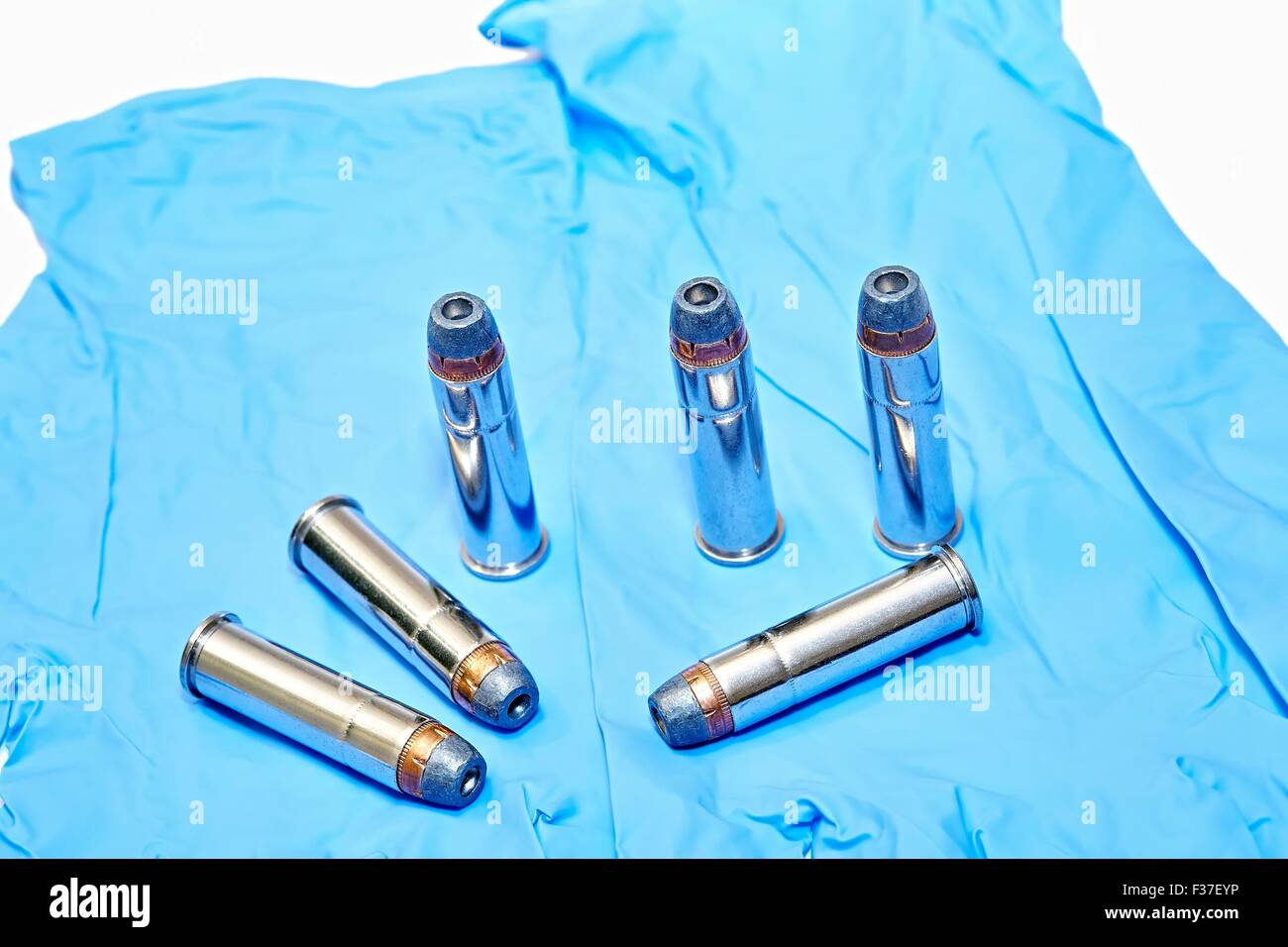 6x 357 cartouches pistolet magnum sur des gants en latex Banque D'Images