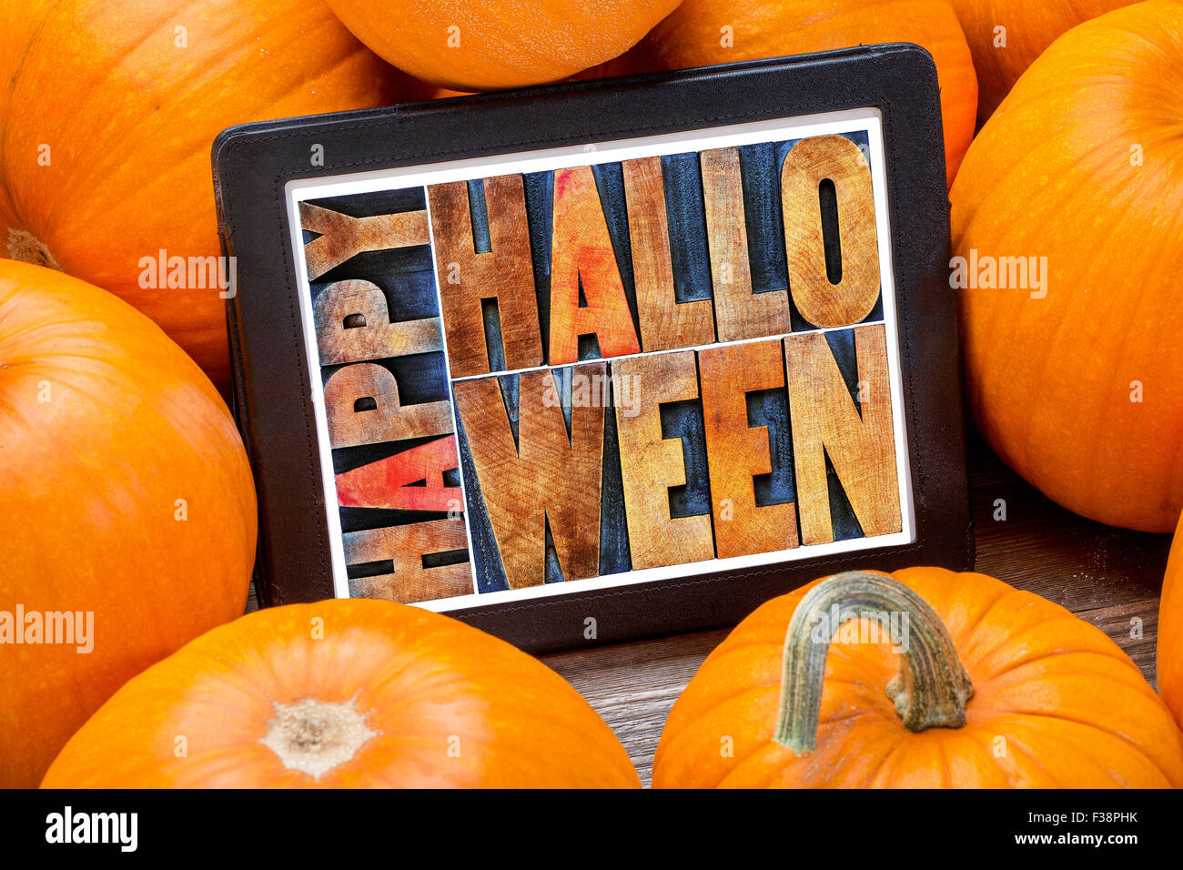 Happy Halloween - le texte du résumé dans la typographie type de bois sur une tablette entouré de citrouilles Banque D'Images
