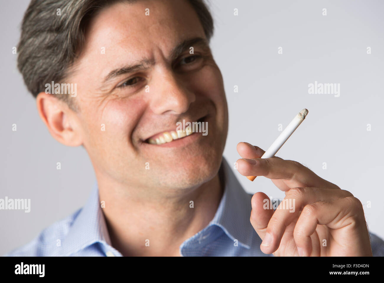 Studio Shot of Man Smoking Cigarette Banque D'Images