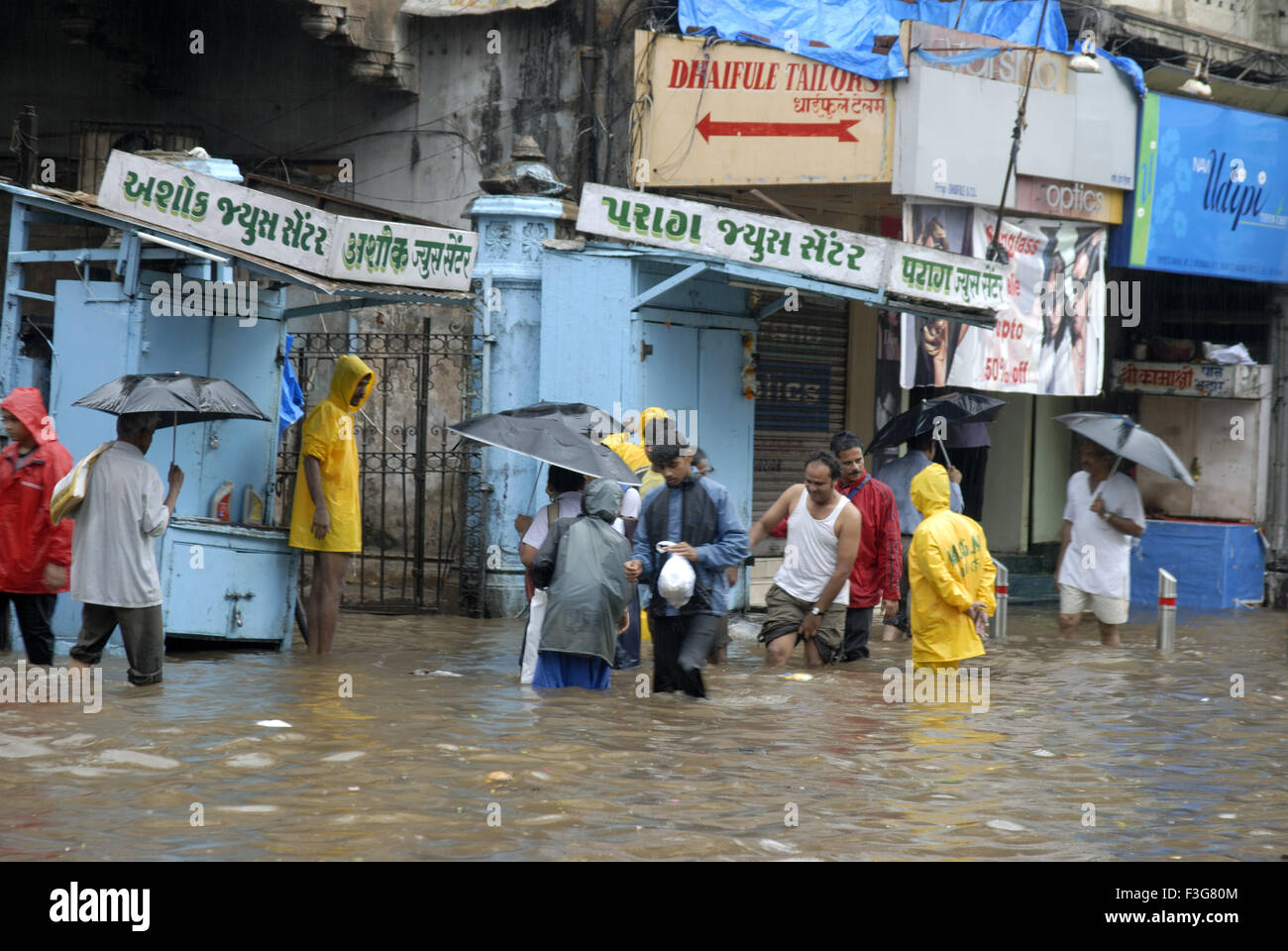 Les personnes qui traversent la route décalée de l'eau à Bombay Dadar Mumbai Maharashtra ; ; ; l'Inde Banque D'Images