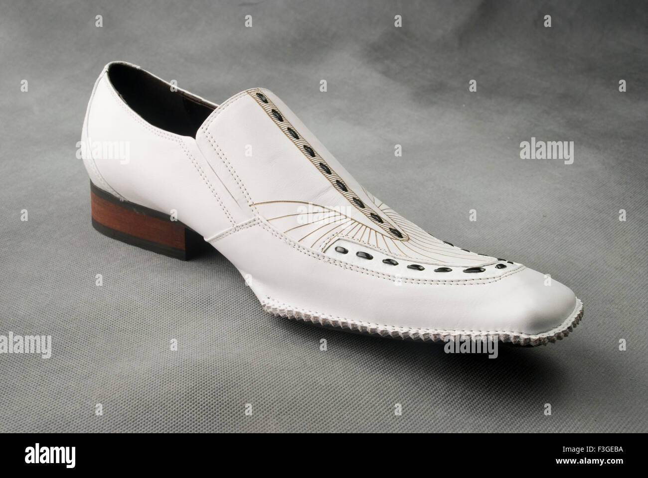 Chaussures en cuir blanc sur fond gris MR Banque D'Images