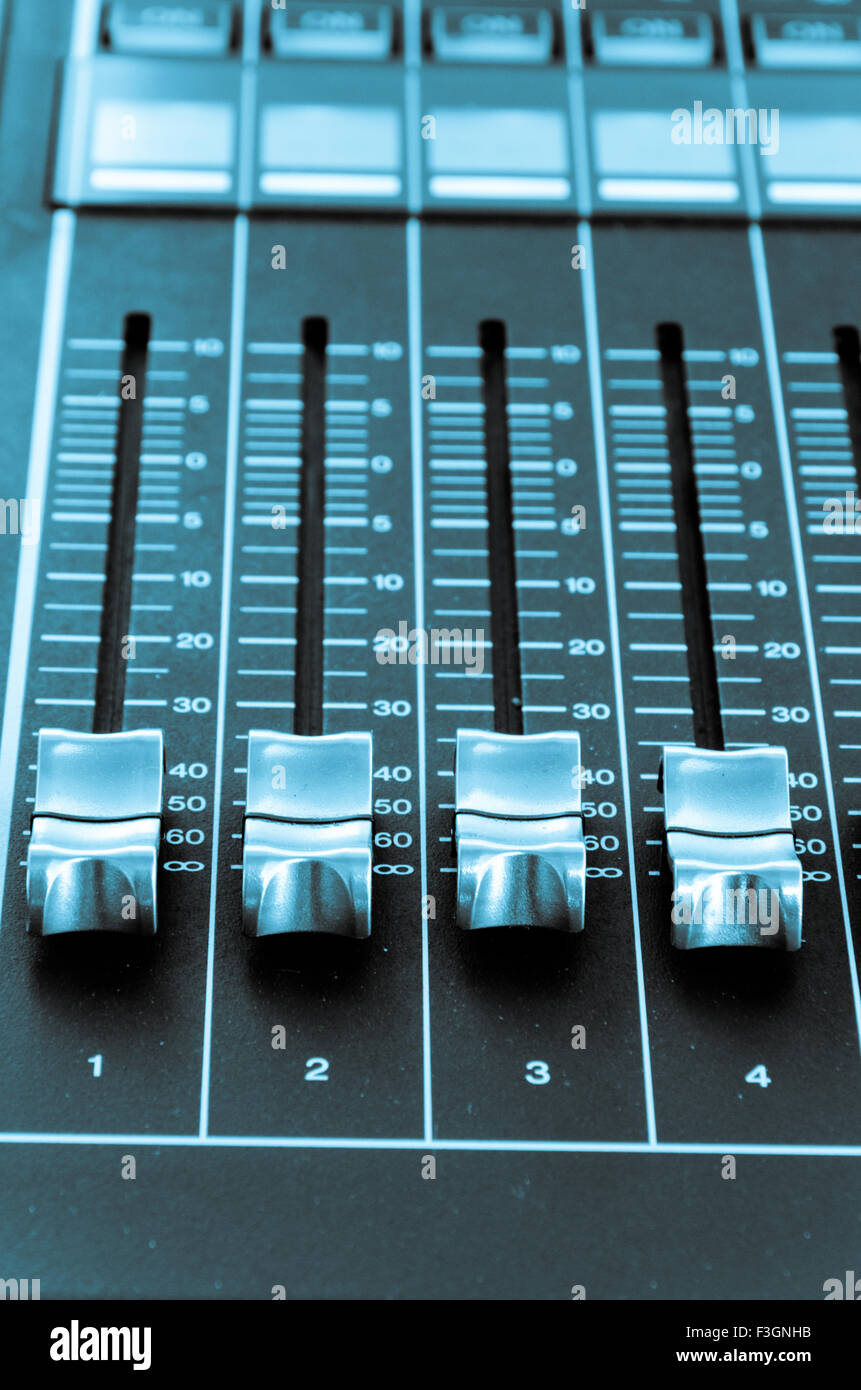 Les boutons d'un mixer de la musique dans l'ambiance de table bleu Banque D'Images