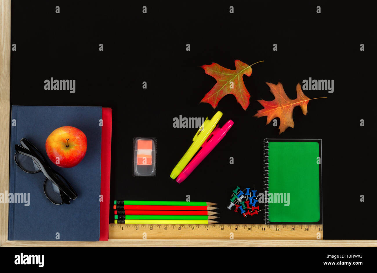 Les fournitures scolaires et les feuilles d'automne sur tableau noir. Retour à l'école concept pour saison d'automne. Banque D'Images