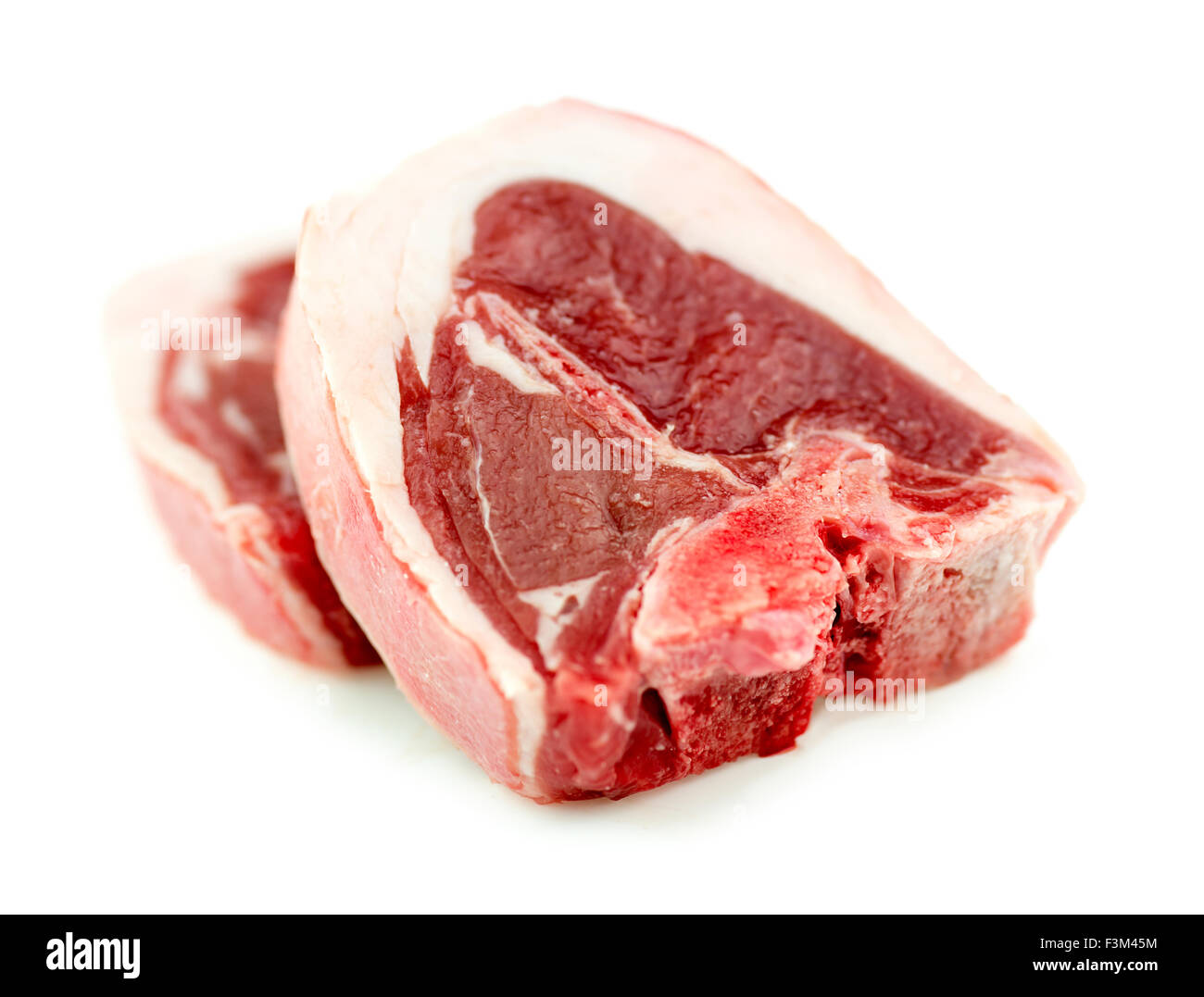 Longe d'agneau cru raw beef chop isolé sur blanc en studio Banque D'Images