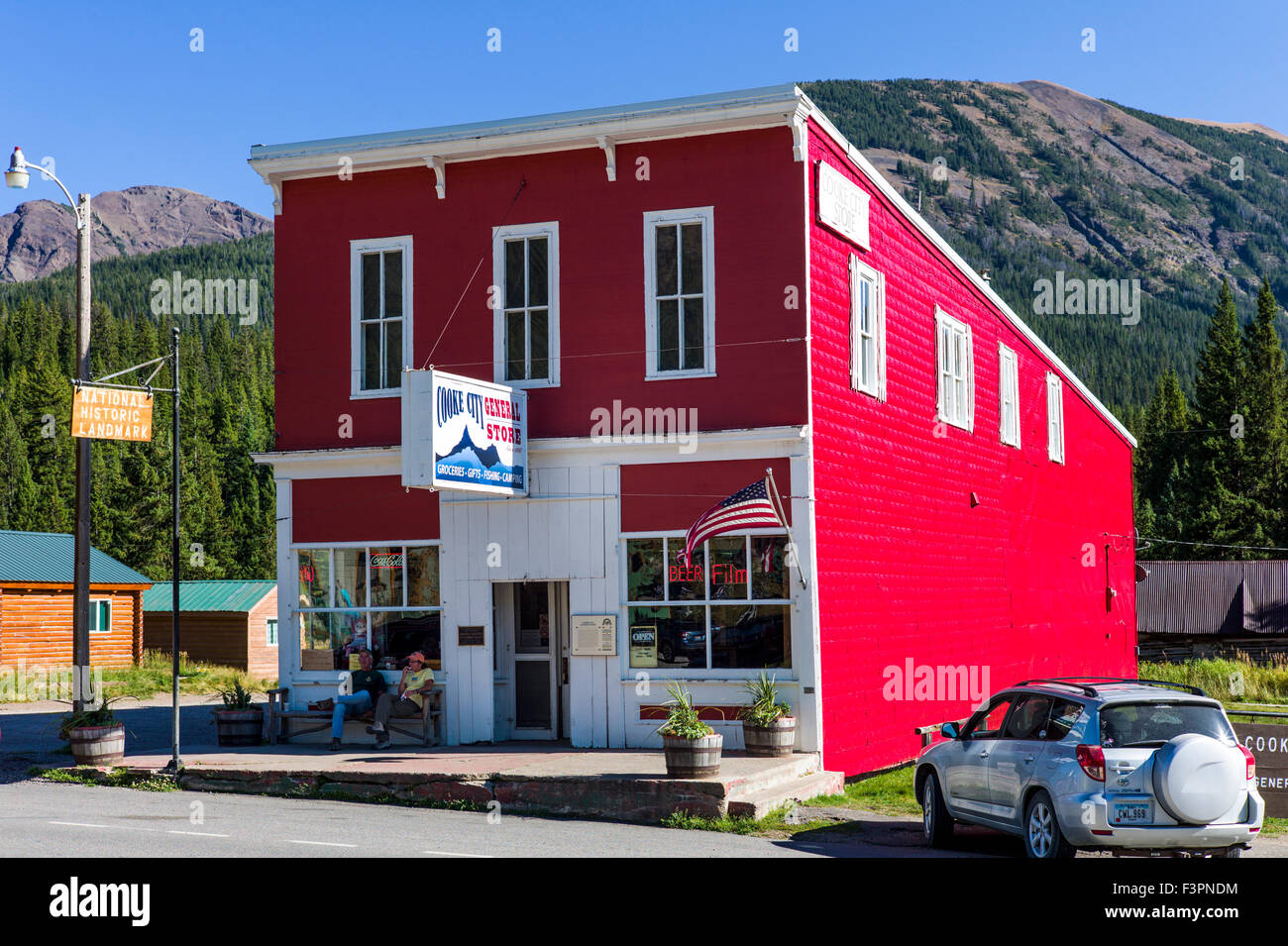 Vue extérieure d'un rouge vif enfoncé revêtement métallique sur Cooke City Magasin Général ; Cooke City, Montana, USA Banque D'Images