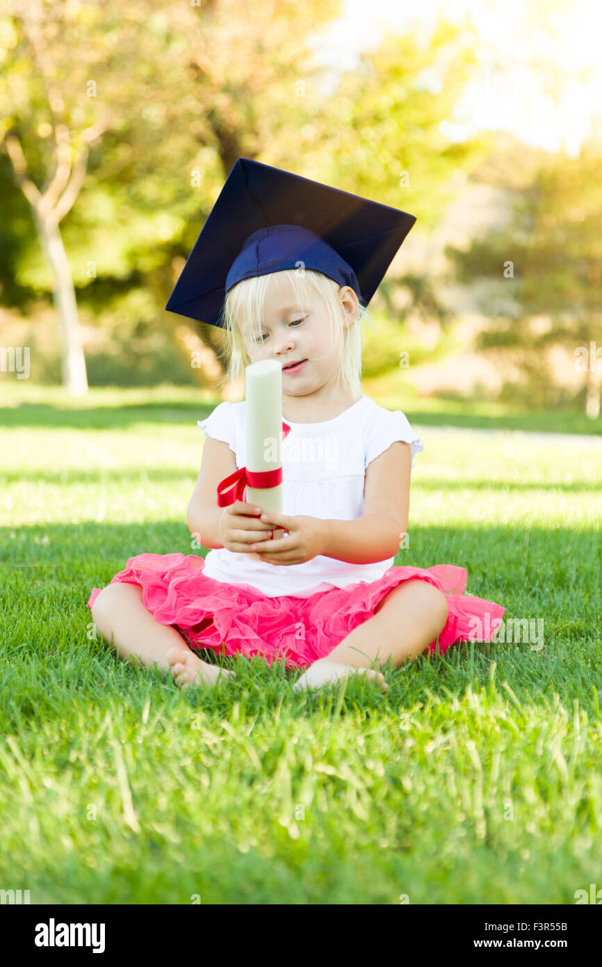 Cute Little Girl In Grass Wearing Graduation Cap Holding Diploma avec ...