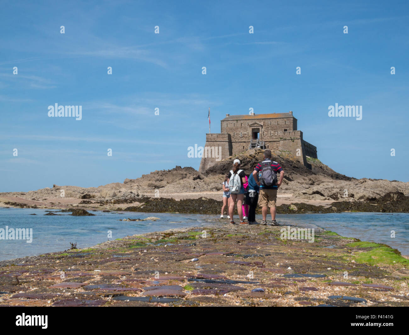 Les touristes à la recherche de Grand Bé forteresse en chemin de pierre à marée basse Banque D'Images