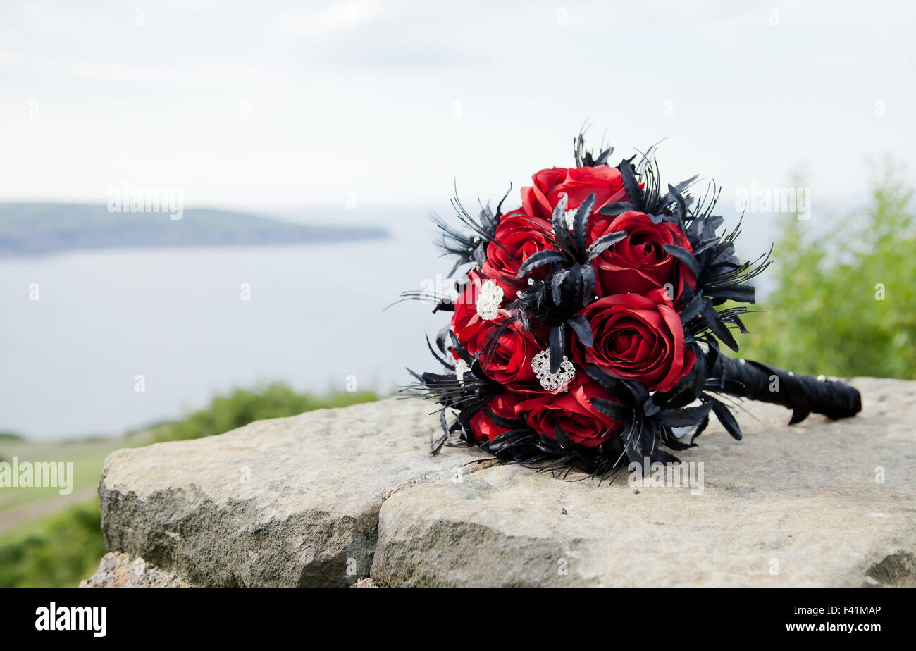 Noir et rouge bouquet de mariage rose sur un mur sur la mer Banque D'Images
