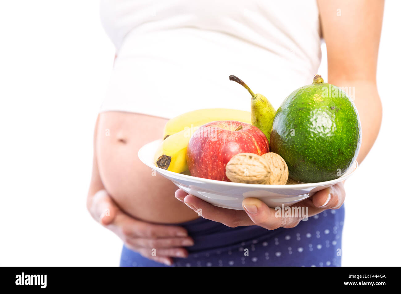 Femme enceinte montrant des fruits et légumes Banque D'Images