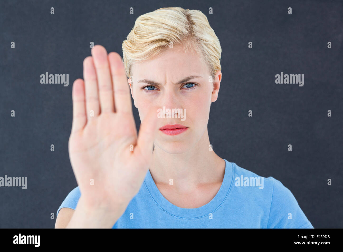 Stern woman gesturing with her hand Banque D'Images