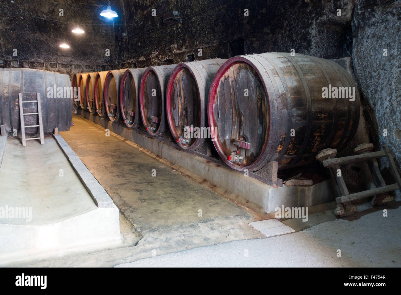 Vieux tonneaux de vin dans la forteresse souterraine du Château de Brézé, France Banque D'Images