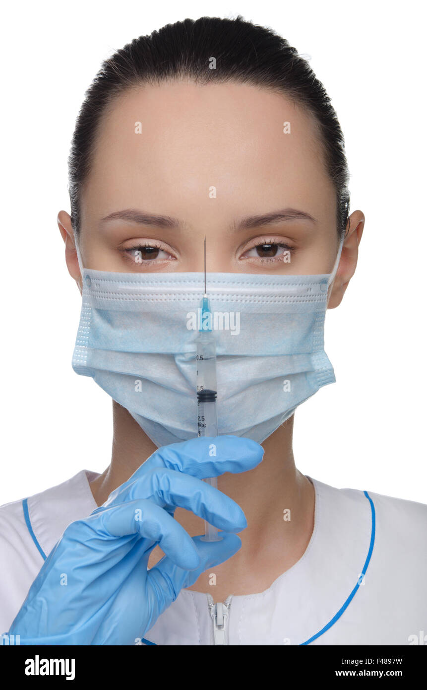Médecin dans un masque et d'une seringue Banque D'Images