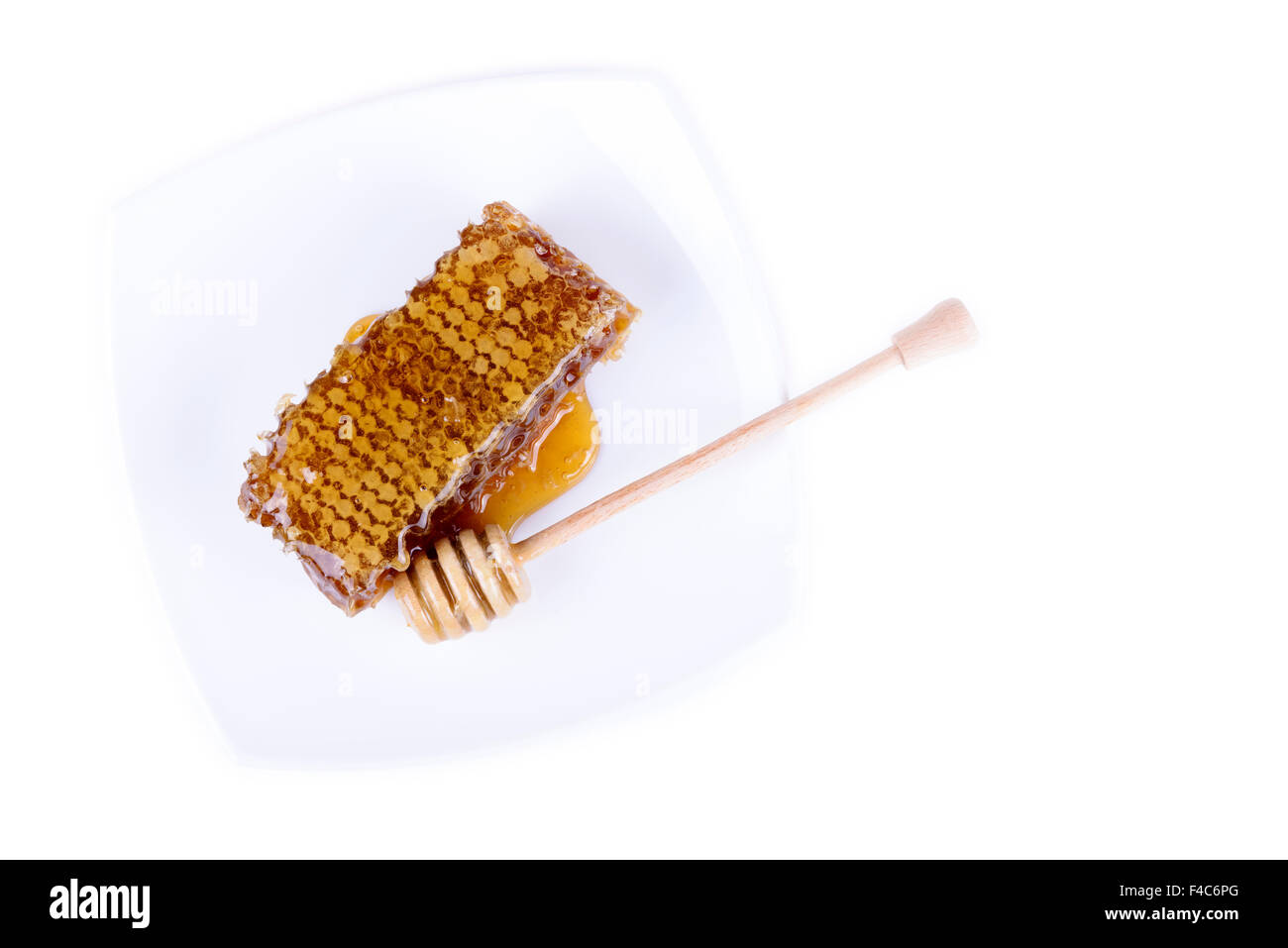 Avec du miel d'abeilles et de miel stick sur fond blanc Banque D'Images