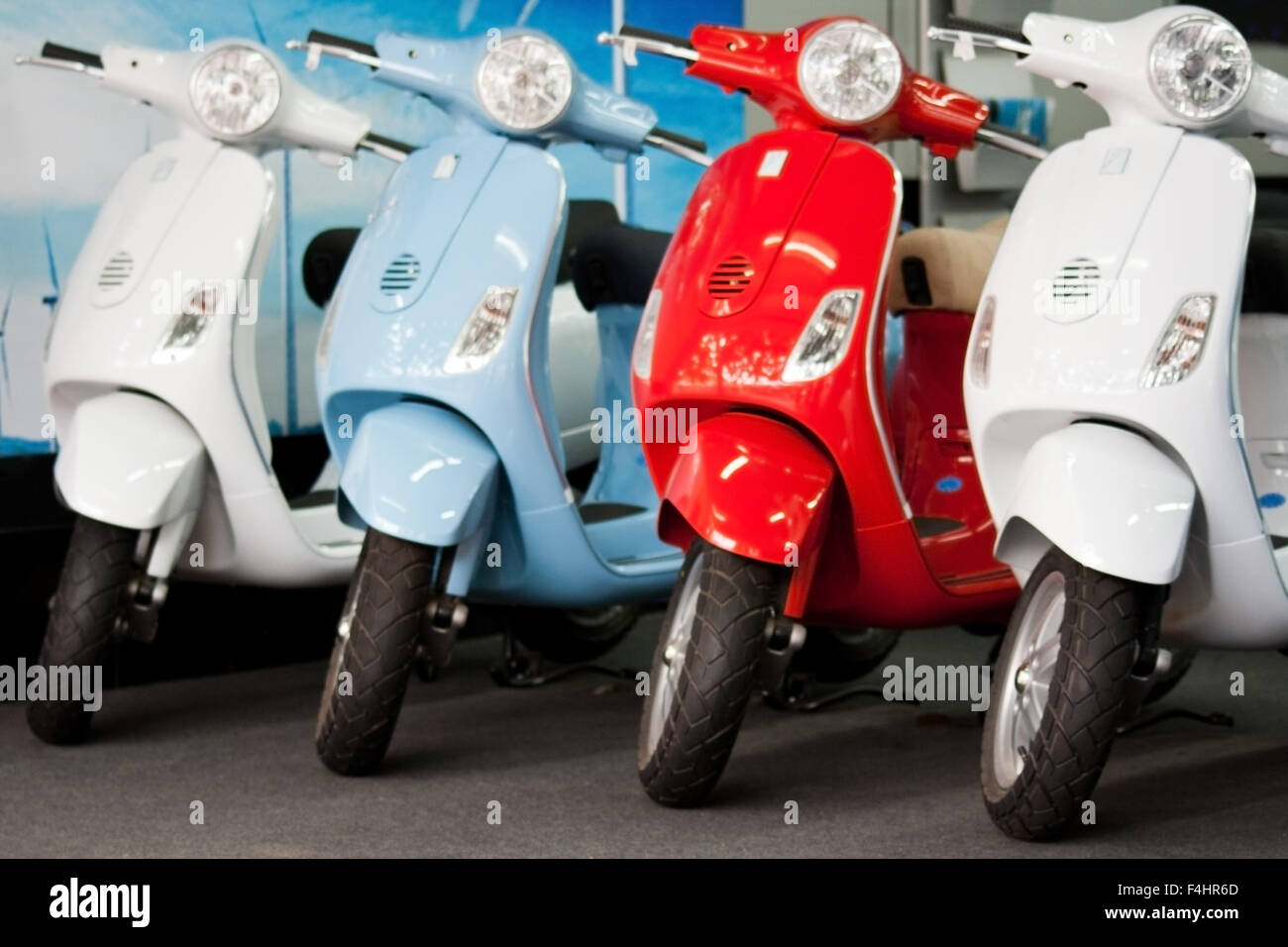 Quatre scooters Vespa de couleur différente dans la salle d'exposition, nouvelle, Vierge immaculée, cool, chic, élégant, cyclomoteurs et iconique italienne mode de transport Banque D'Images