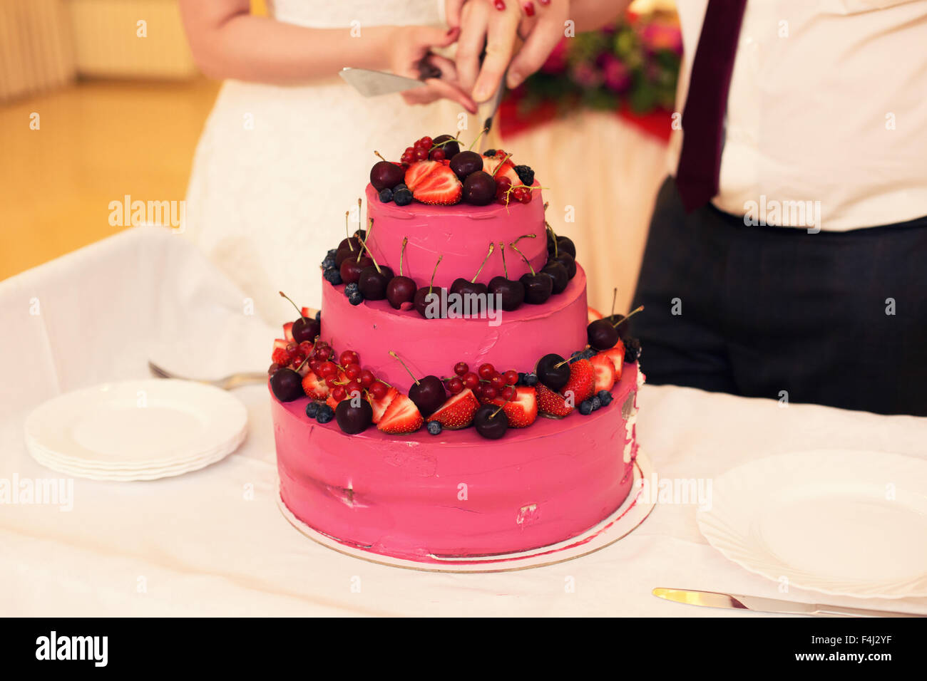 Le couple couper le gâteau de mariage Banque D'Images Le couple couper le gâteau de mariage Banque D'Images