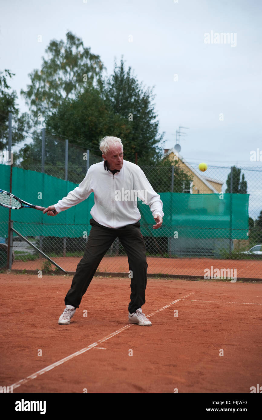 Senior man playing tennis Banque D'Images