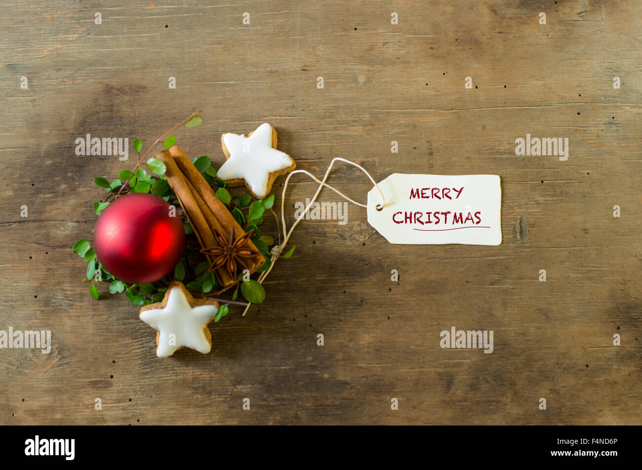 Décoration de Noël avec des bâtons de cannelle et les étoiles et une boule de Noël rouge sur bois Banque D'Images