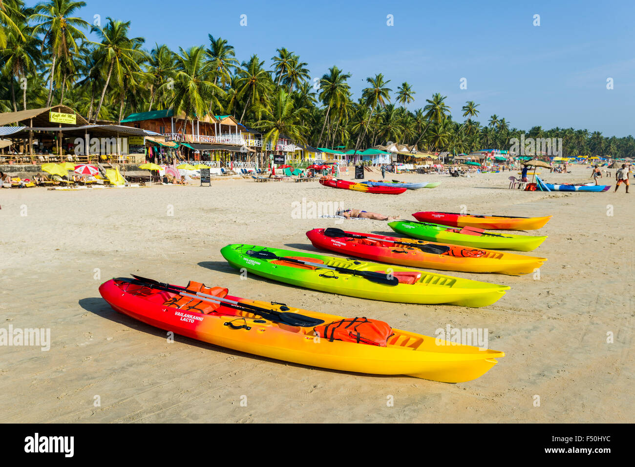 Certains kayaks colorés sont à louer à la plage de Palolem avec ciel bleu, de palmiers et de sable blanc Banque D'Images