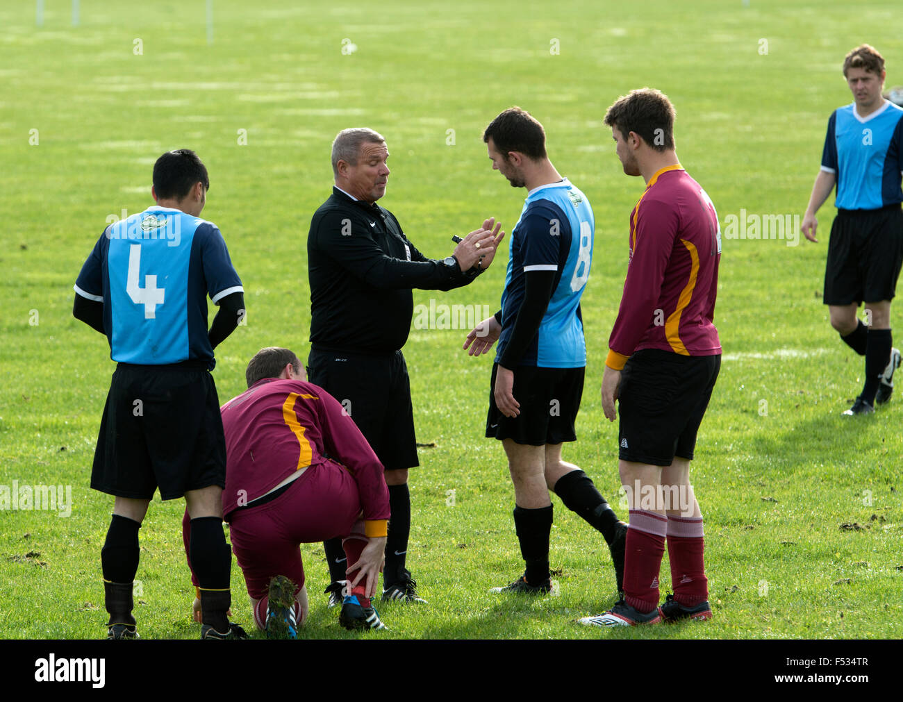 Football Ligue dimanche, arbitre de parler à un joueur Banque D'Images