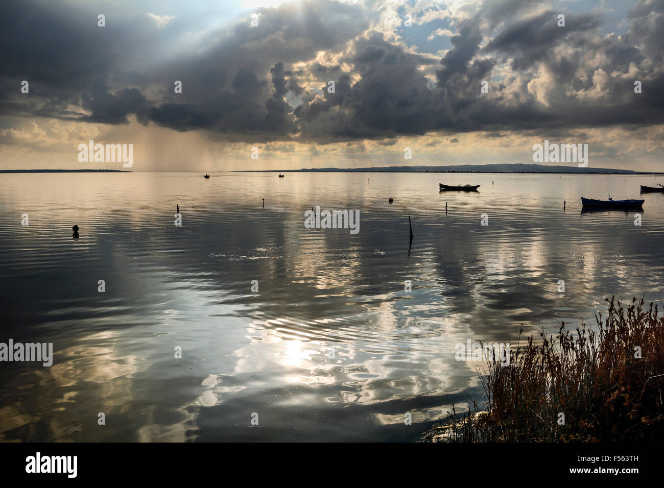 Coucher du soleil dans le lagon, où les pêcheurs retour à l'approche de la tempête imminente. Aube. Les îles de la Méditerranée. Banque D'Images