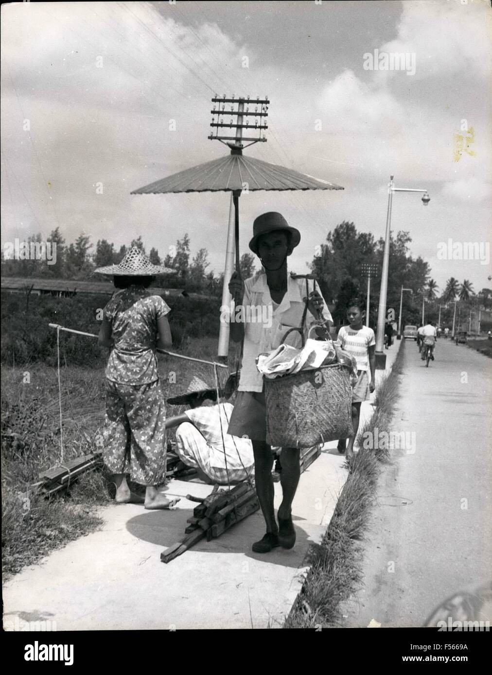 1968 - Singapour périphérie : le zoo des gens passer sur le trottoir. Un marchand transportant ses marchandises au marché esnot seulement un chapeau de soleil, mais aussi un pare-soleil. Les femmes exerçant leur charge au même marché reste à mi-chemin. (Crédit Image : © Keystone Photos USA/ZUMAPRESS.com) Banque D'Images