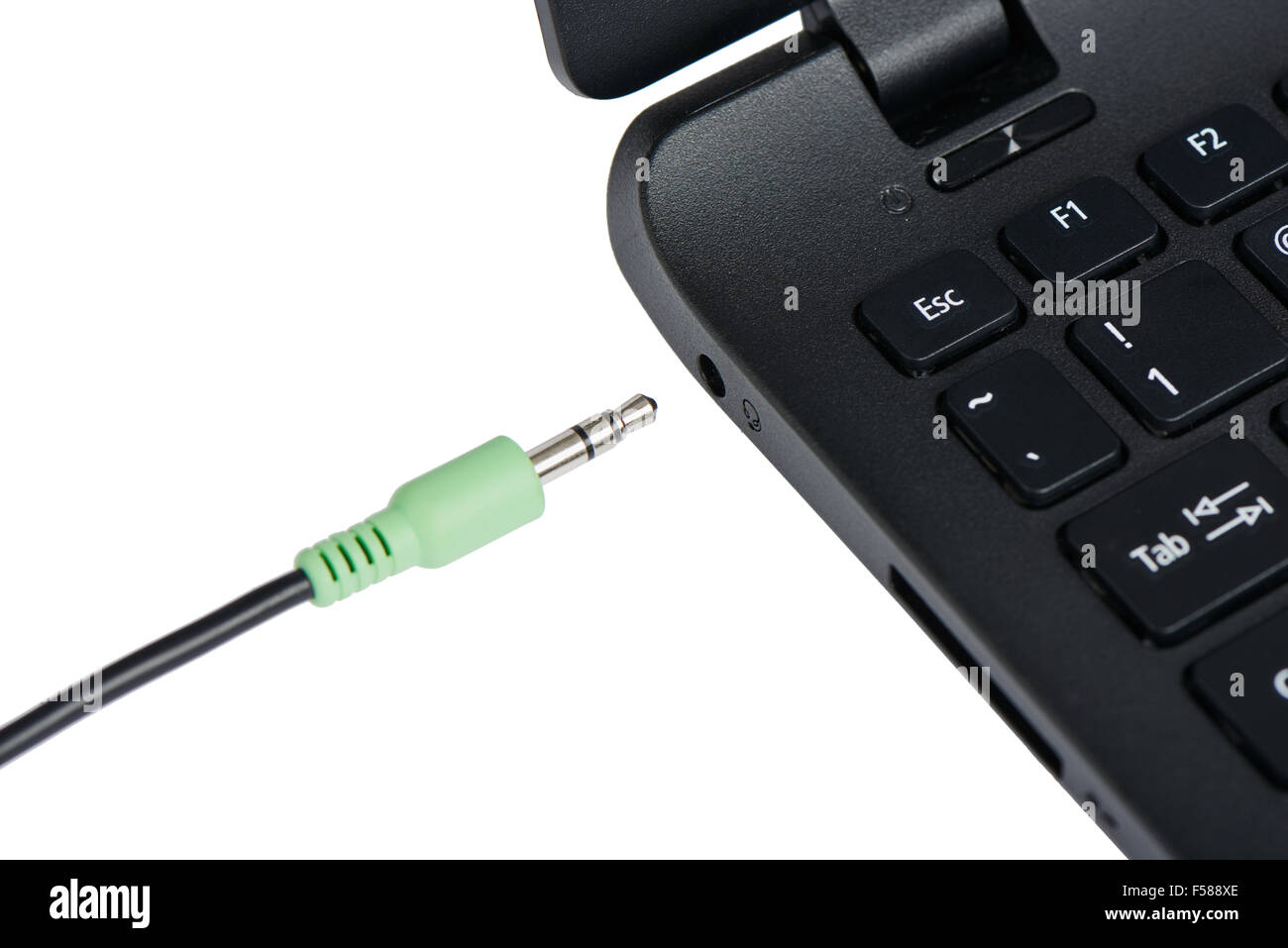 Câble audio stéréo de gros plan et la borne à un ordinateur portable, isolé sur blanc. Banque D'Images