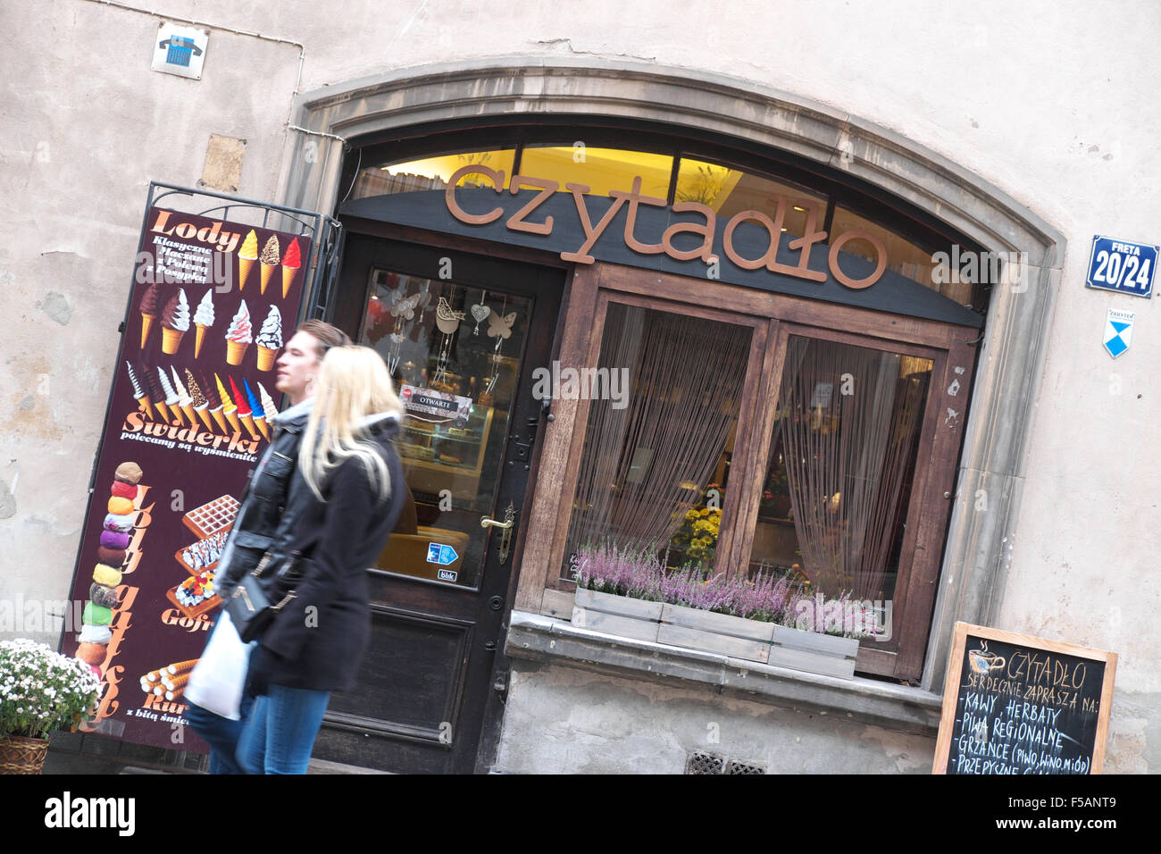 Pologne Varsovie deux personnes passent devant un café dans la vieille ville à l'automne. Banque D'Images
