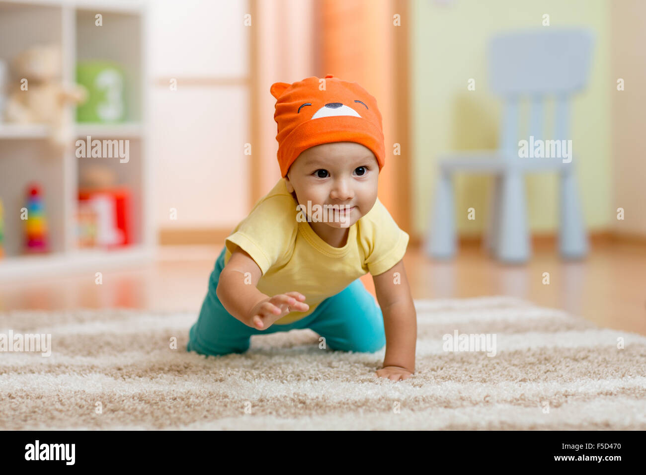 Ramper bébé garçon à la maison sur marbre Banque D'Images