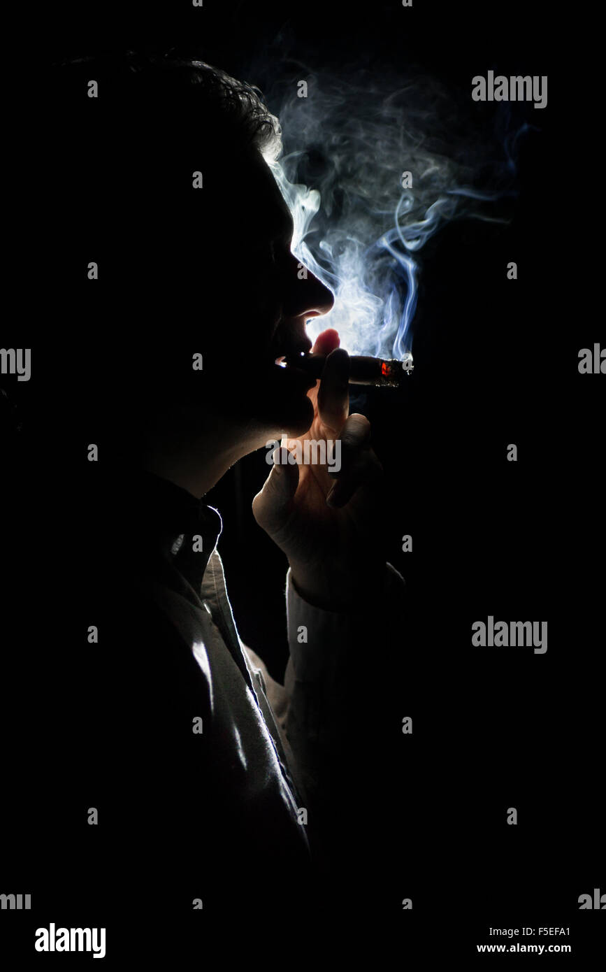 Silhouette d'un homme smokinga cigar Banque D'Images