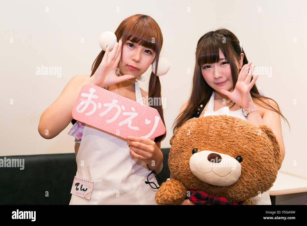 Les membres du personnel de dix (18) (à gauche) et Hime (19), posent en photo au "Ore no Yome' cafe avec un 'Welcome Home' signe à Ikebukuro, le 4 novembre 2015, Tokyo, Japon. 'Ore No Yome' qui signifie littéralement ''Ma femme'' est l'un des derniers concepts café bizarre à Tokyo où femmes portant des bikinis et un tablier vous accueillir par votre prénom et servent des boissons et le dîner. Le café est destiné aux salarymen fatigués qui veulent un peu de confort après le travail, mais aussi des hommes qui portent des shorts serrés et agira en tant que votre 'darling' pour la soirée pour les clients. Selon le propriétaire, le café wil Banque D'Images