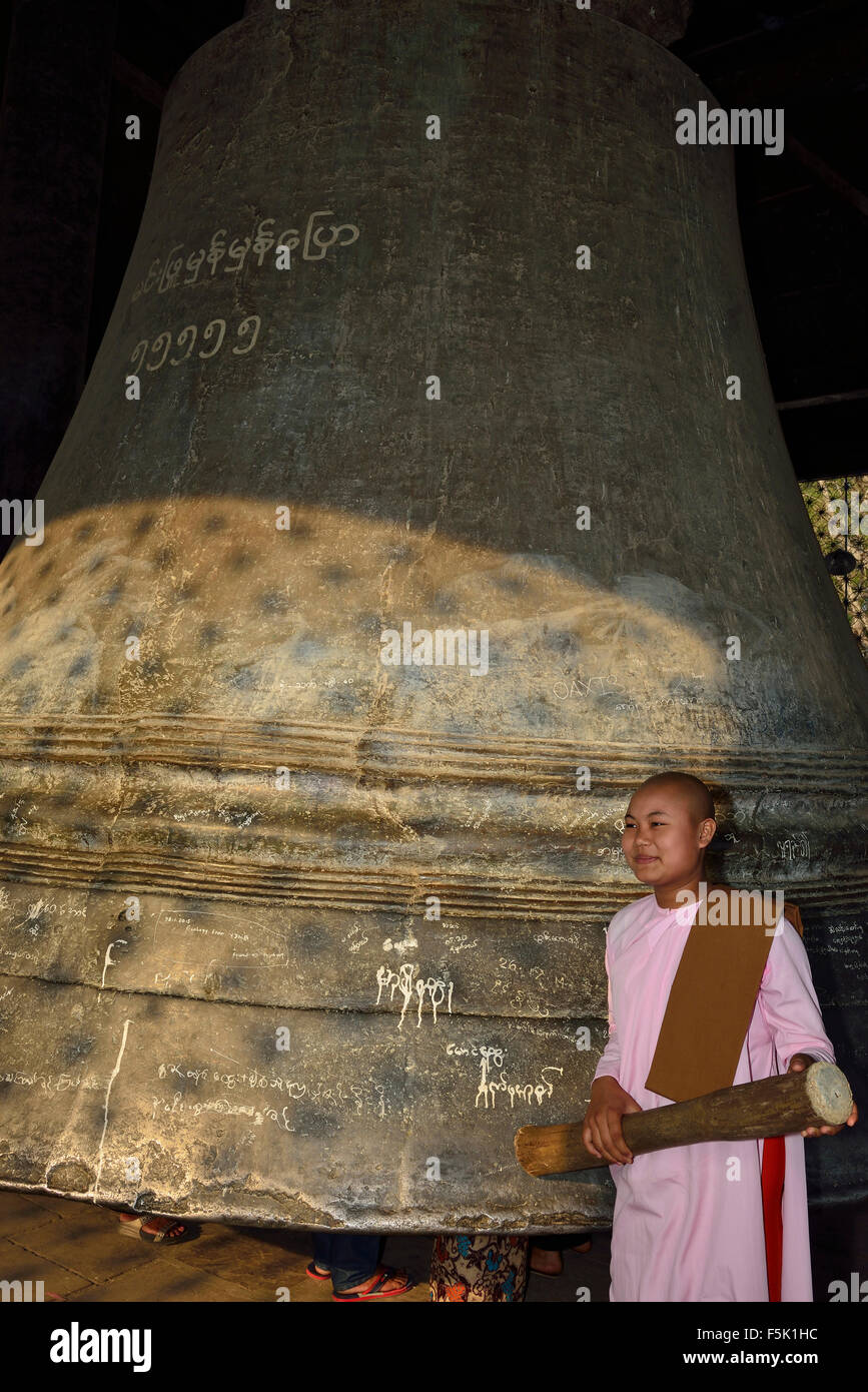 Une novice sonnant la grande cloche, à une époque la plus grande cloche au monde à Mingun, dans la région de Sagaing, au Myanmar (anciennement Birmanie), en Asie du Sud-est Banque D'Images