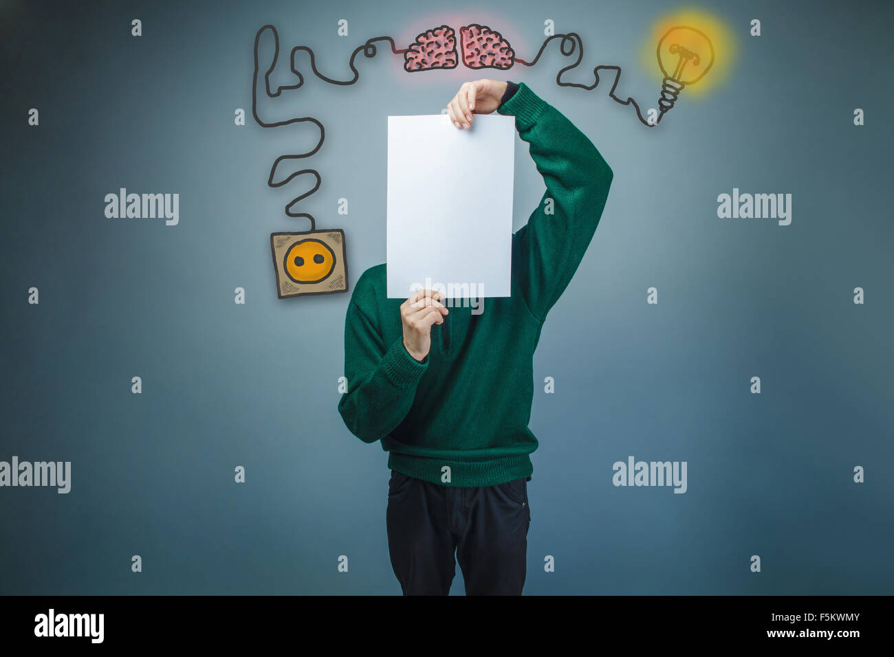 Teen boy le visage couvert d'une feuille de papier cordon de charge pl Banque D'Images